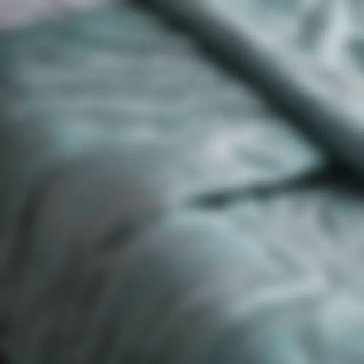 Close-up of the fabric texture of grey and aqua comforter