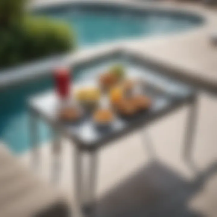 Modern metal snack table with minimalist design beside a pool